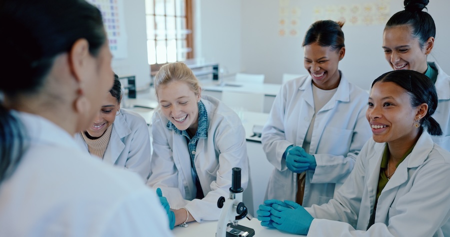 Science, laboratory and teacher with happy students for learning, education and research at medical.