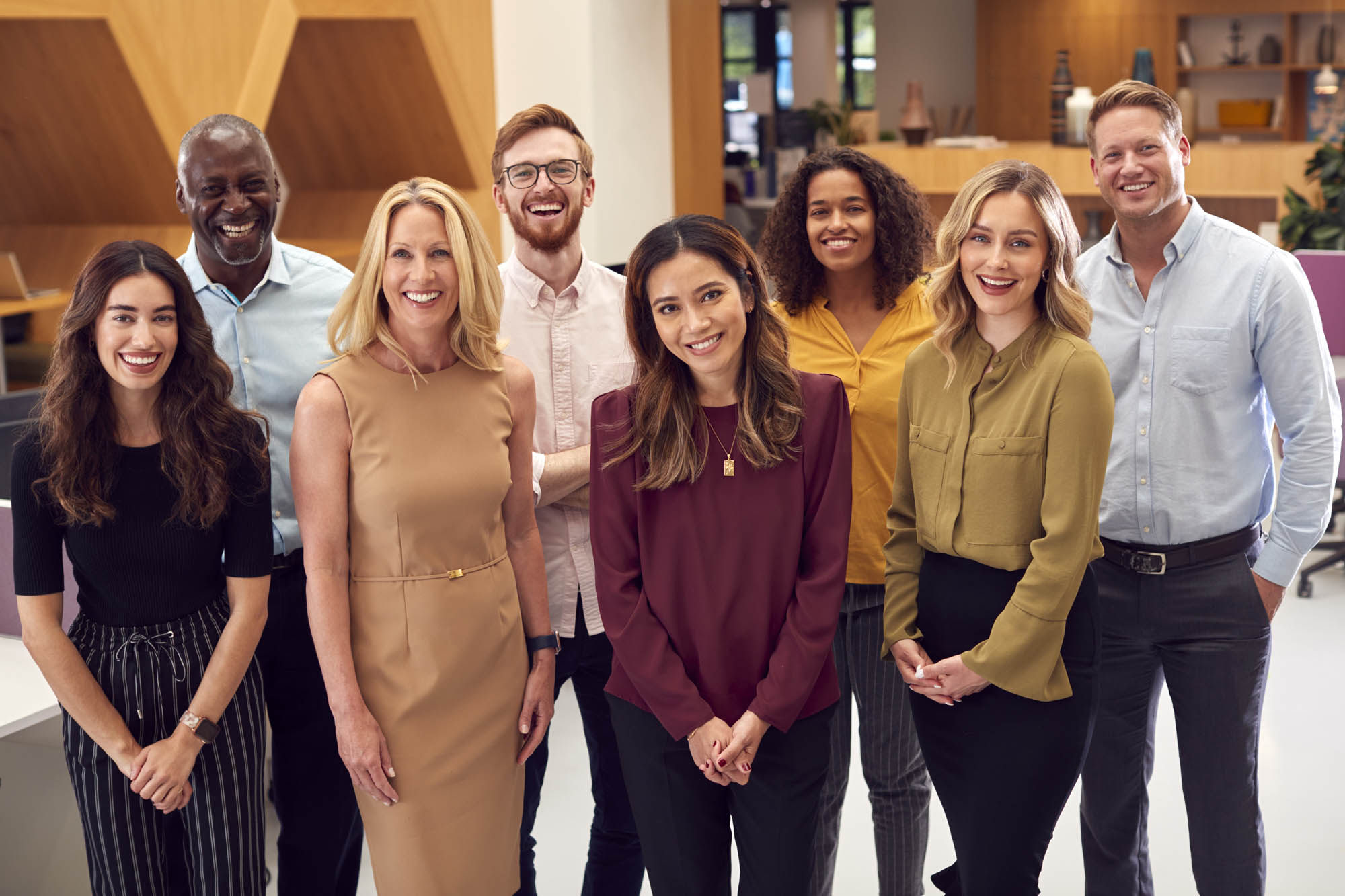 Portrait Of Smiling Multi-Cultural Business Team Standing In Mod